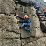 Laying back climbing move at Stanage edge