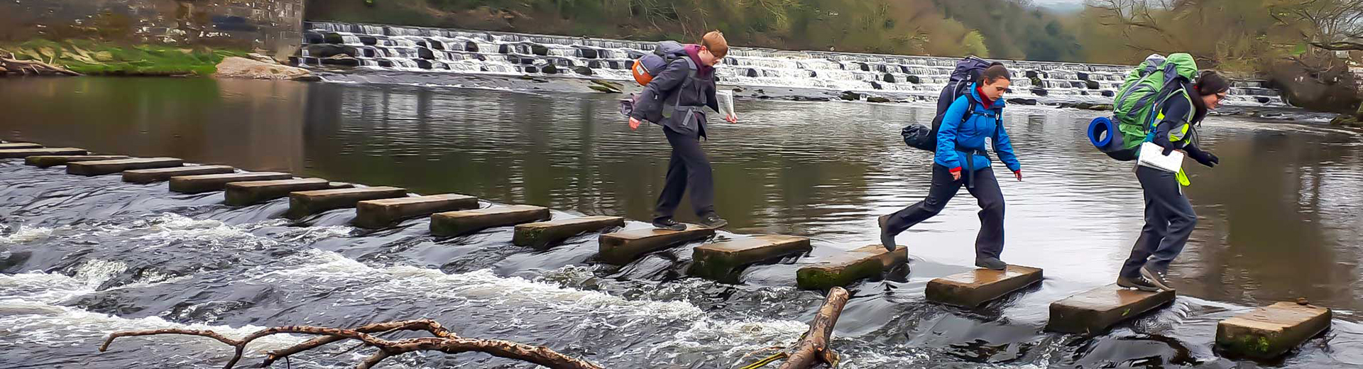 DofE group crossing stepping stones